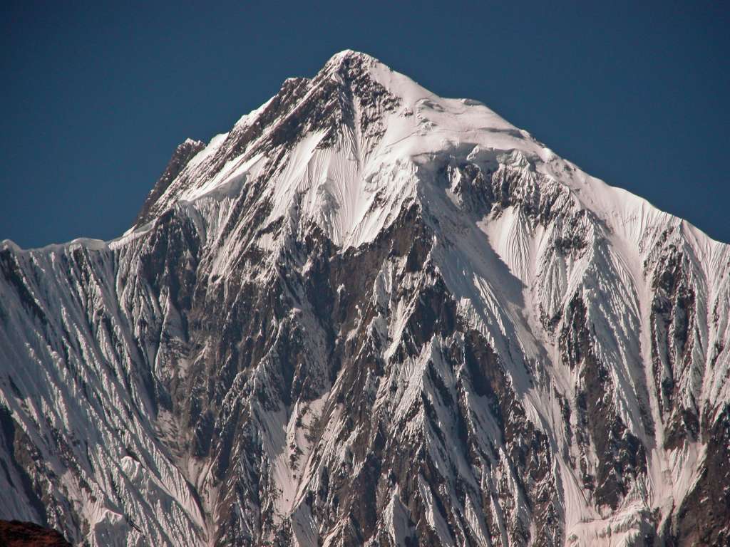 Annapurna 11 02 Annapurna II On The Way To Chame On the way to Chame, I had this magnificent view of Annapurna II (7937m) peaking out from the trees, with the summit ridge leading from right to left.